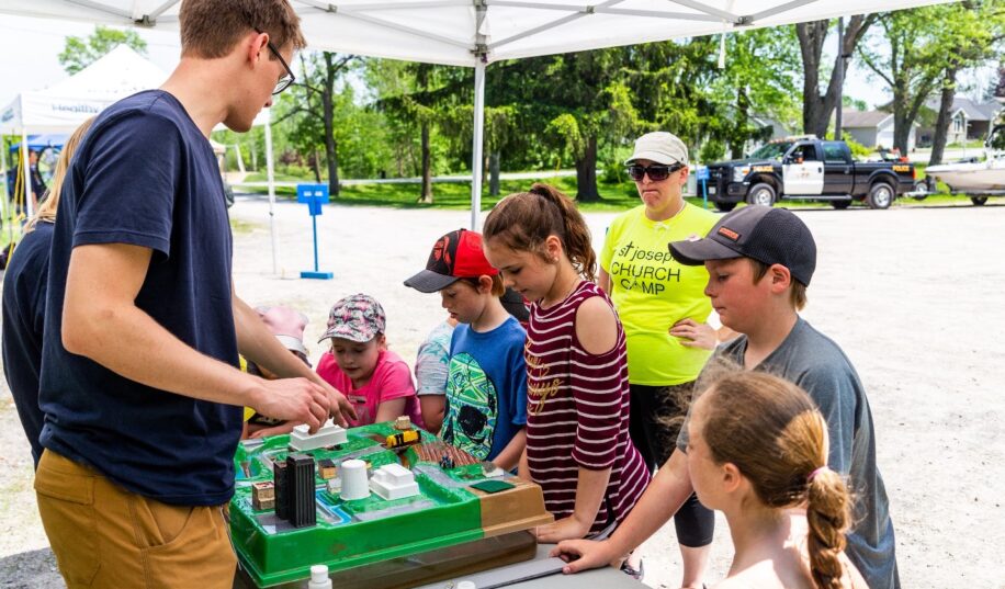 Children looking at a watershed model presented by a teacher