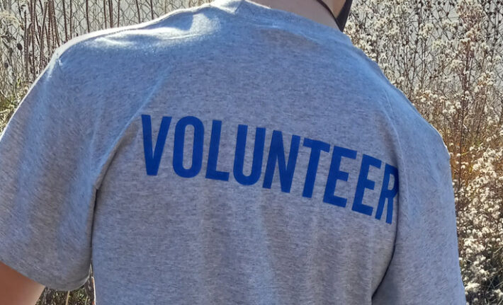 Volunteer wearing a t-shirt that says volunteer