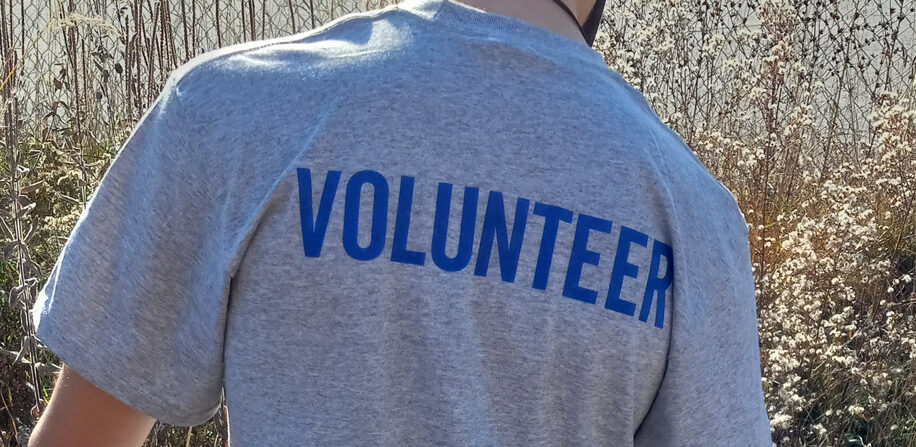 Volunteer wearing a t-shirt that says volunteer